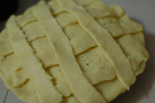 making apple pie: decorating with dough strips making apple pie: decorating with dough strips